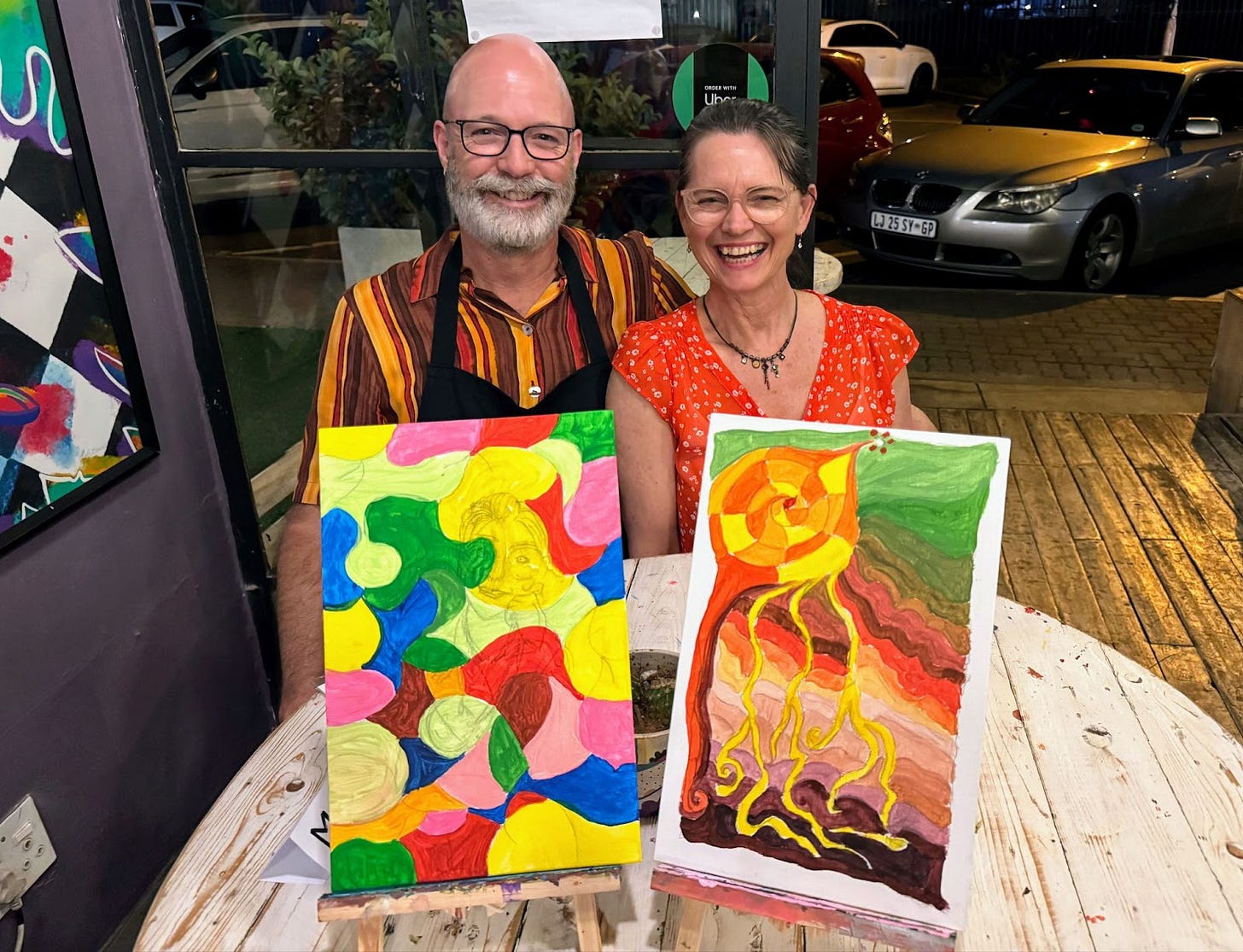 Sitting with our two art pieces from Joons Art Bar: the colourful fruits of our labour. Together, we’re calling them ‘Unfinished and Abstract – Inspirations of Colour.