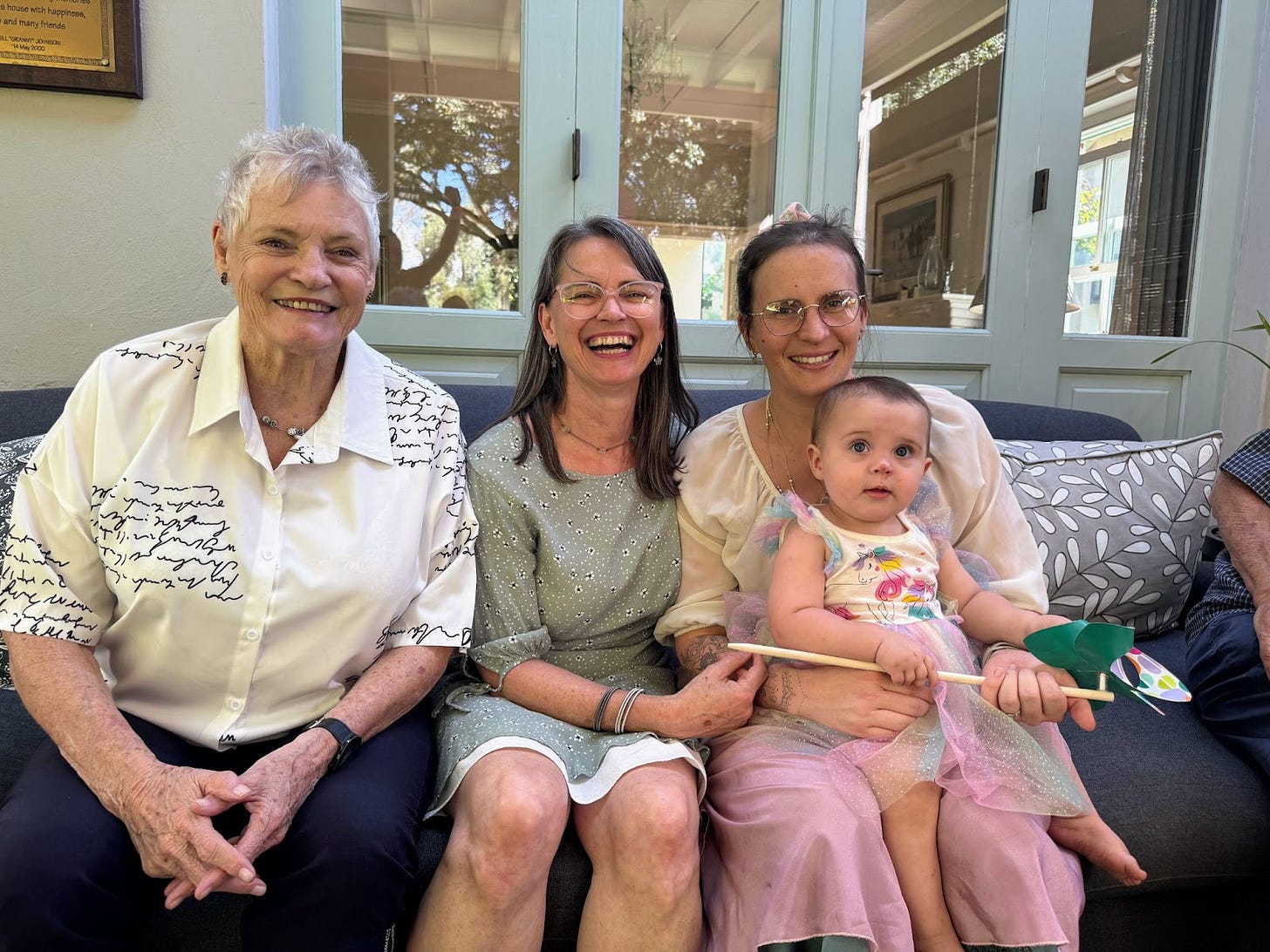 Four generations of strength, love, and a little cake on the side, from wisdom to wonder in one frame!