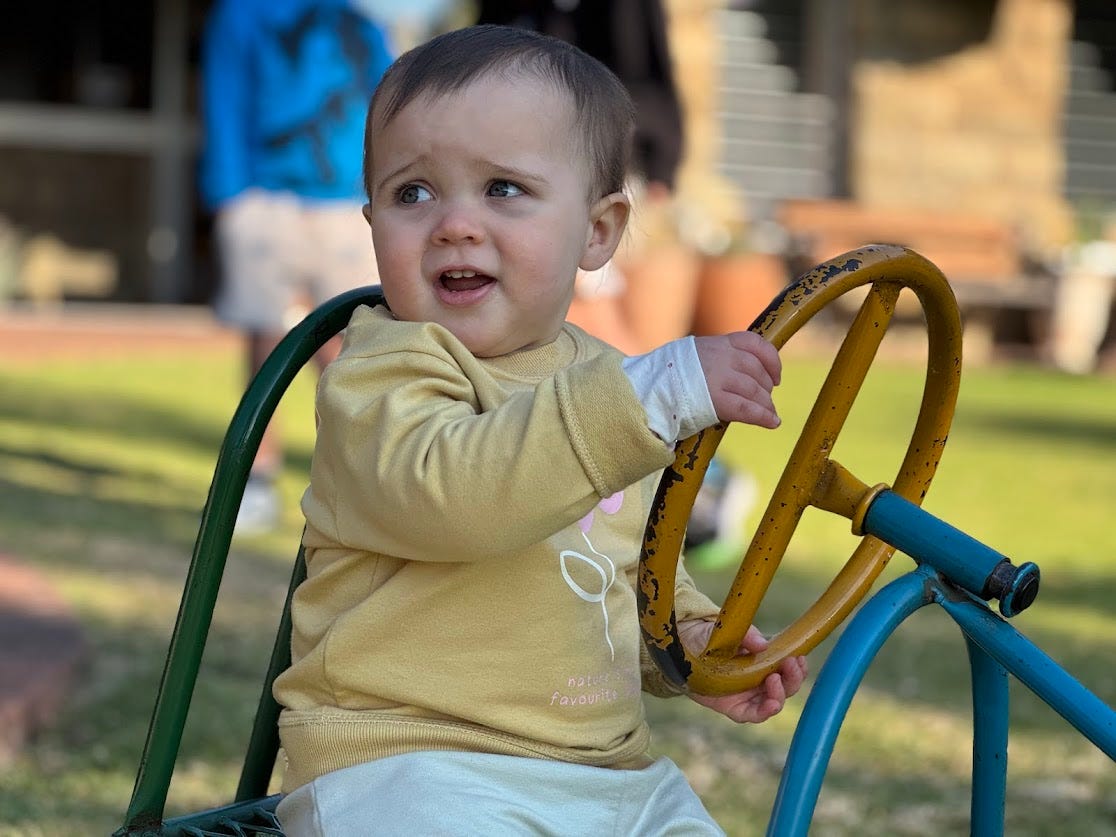 She’s not sure where she’s going, but the grip is firm and the curiosity real. 🧸💛